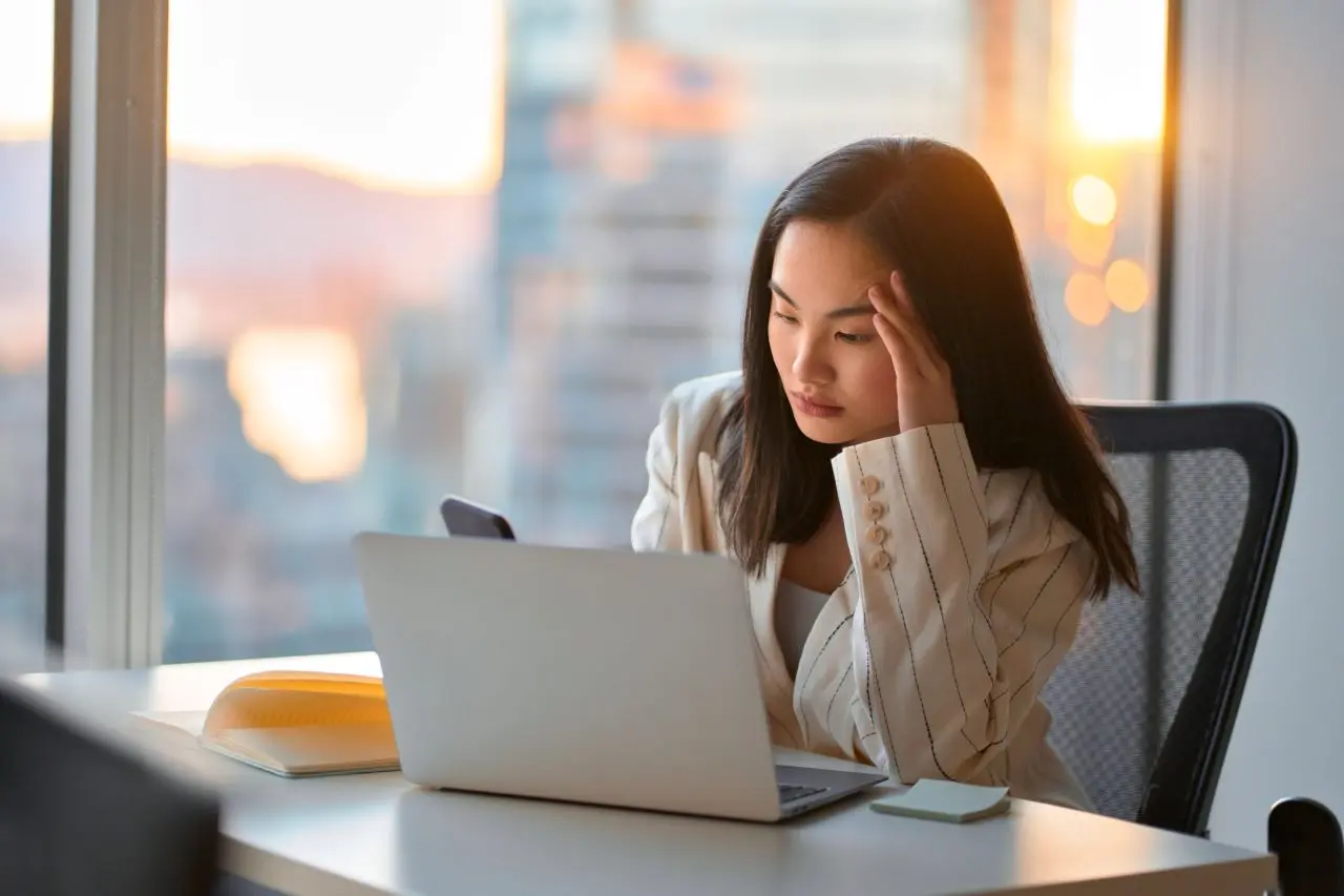 Frustrated person sitting on a desk